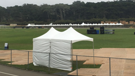 An image of a small tent next to a short fence