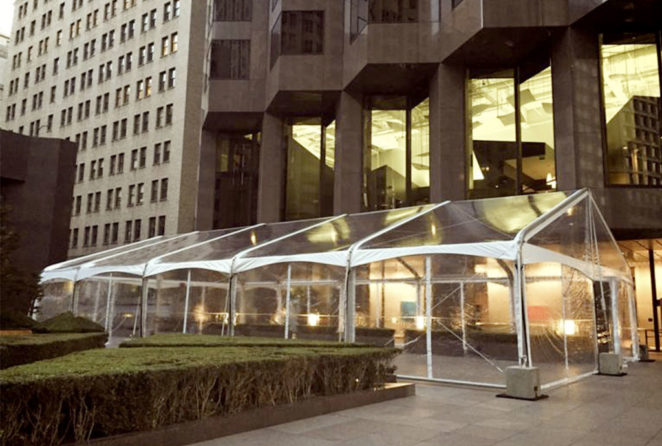 a photo of a 40x80 Clear Top Fastrack Tent along building promenade to allow for additional lobby space for an evening reception