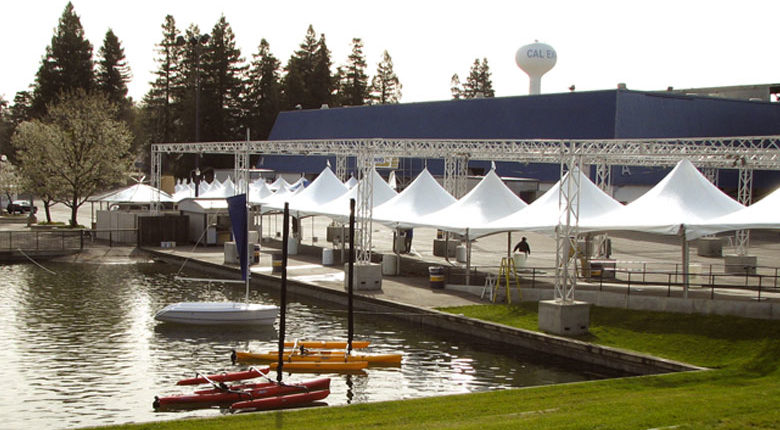 An image of small tents by a boat dock