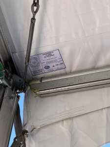 Image of a flame certificate showing a fabric registration number, required by Cal Fire to be placed on the vinyl of ever temporary membrane installed by professional tent companies